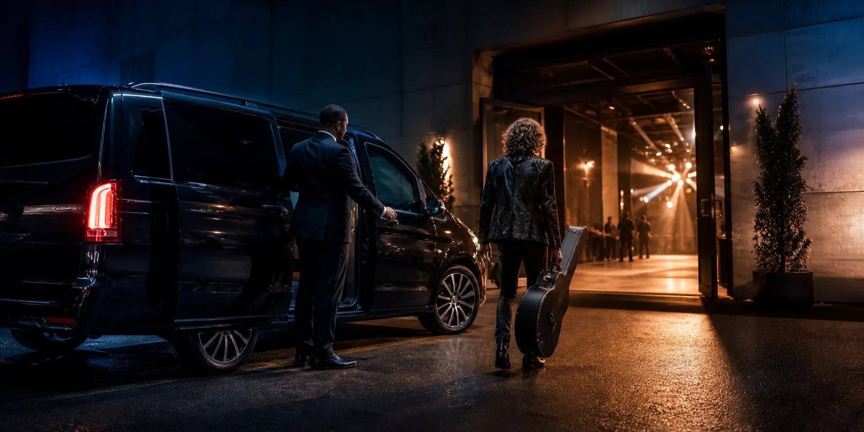 An evening arrival by car at a venue entrance